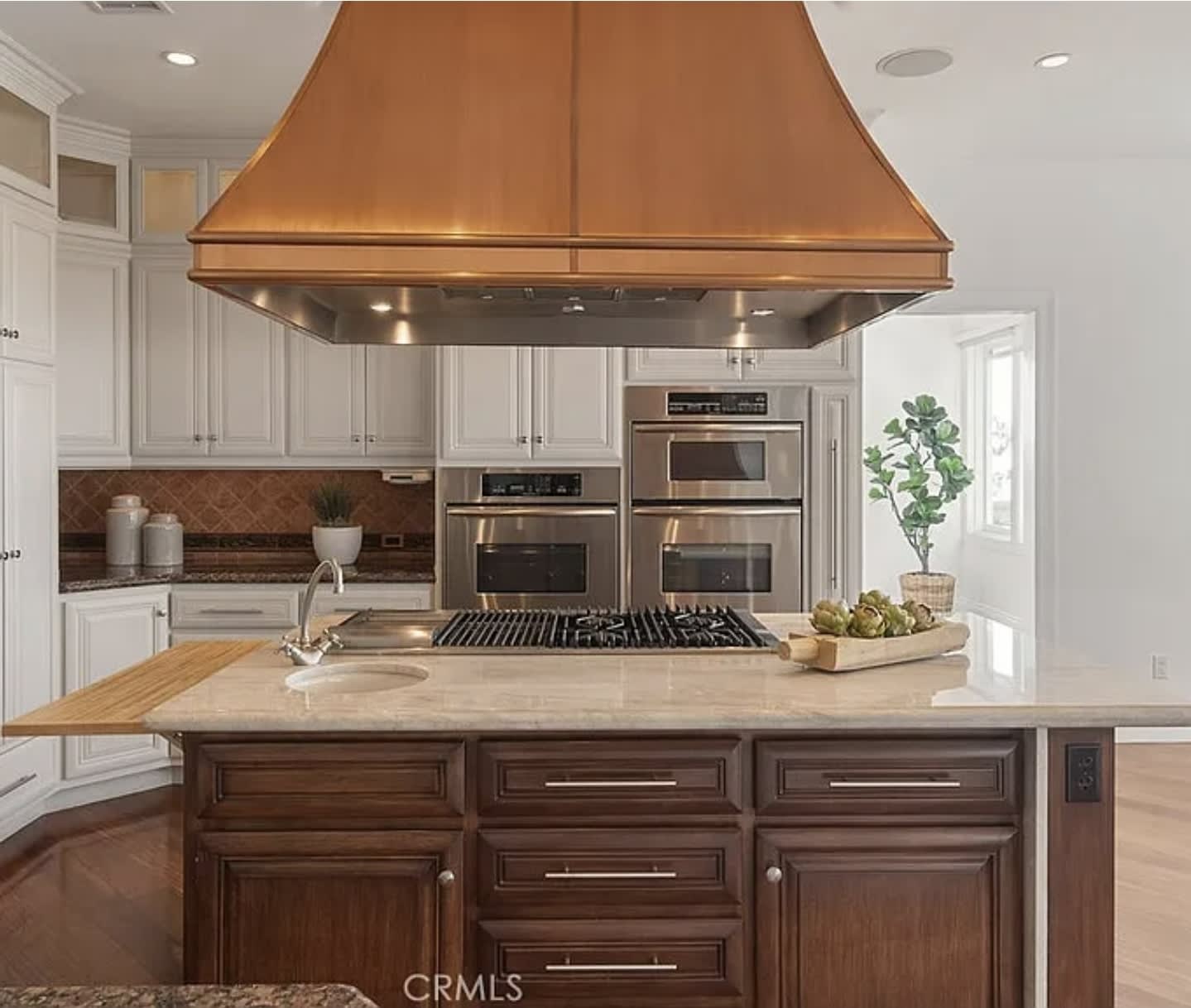 Home remodel materials including cherry wood kitchen cabinets, copper fixtures, and bathroom cabinets