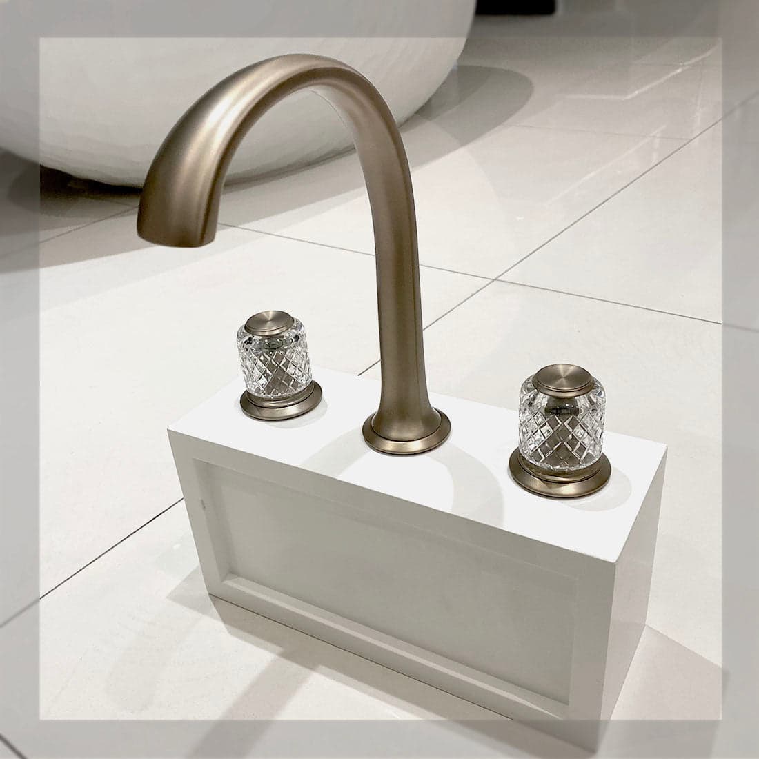 Kallista Script Sink Faucet Set with arch spout, brushed bronze finish, and flannel grey crystal knob handles