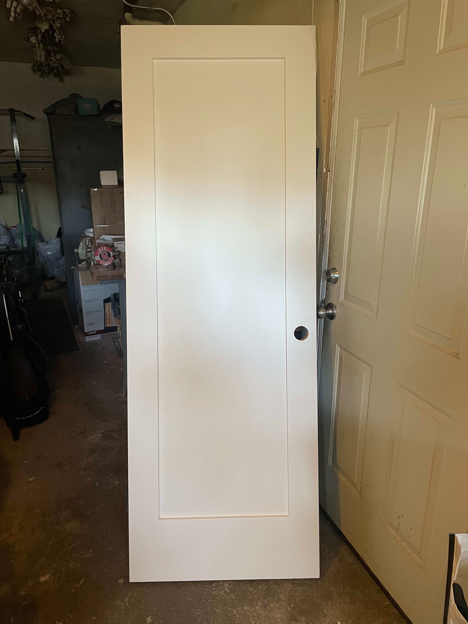 White painted solid wood interior door with black hinges and knob
