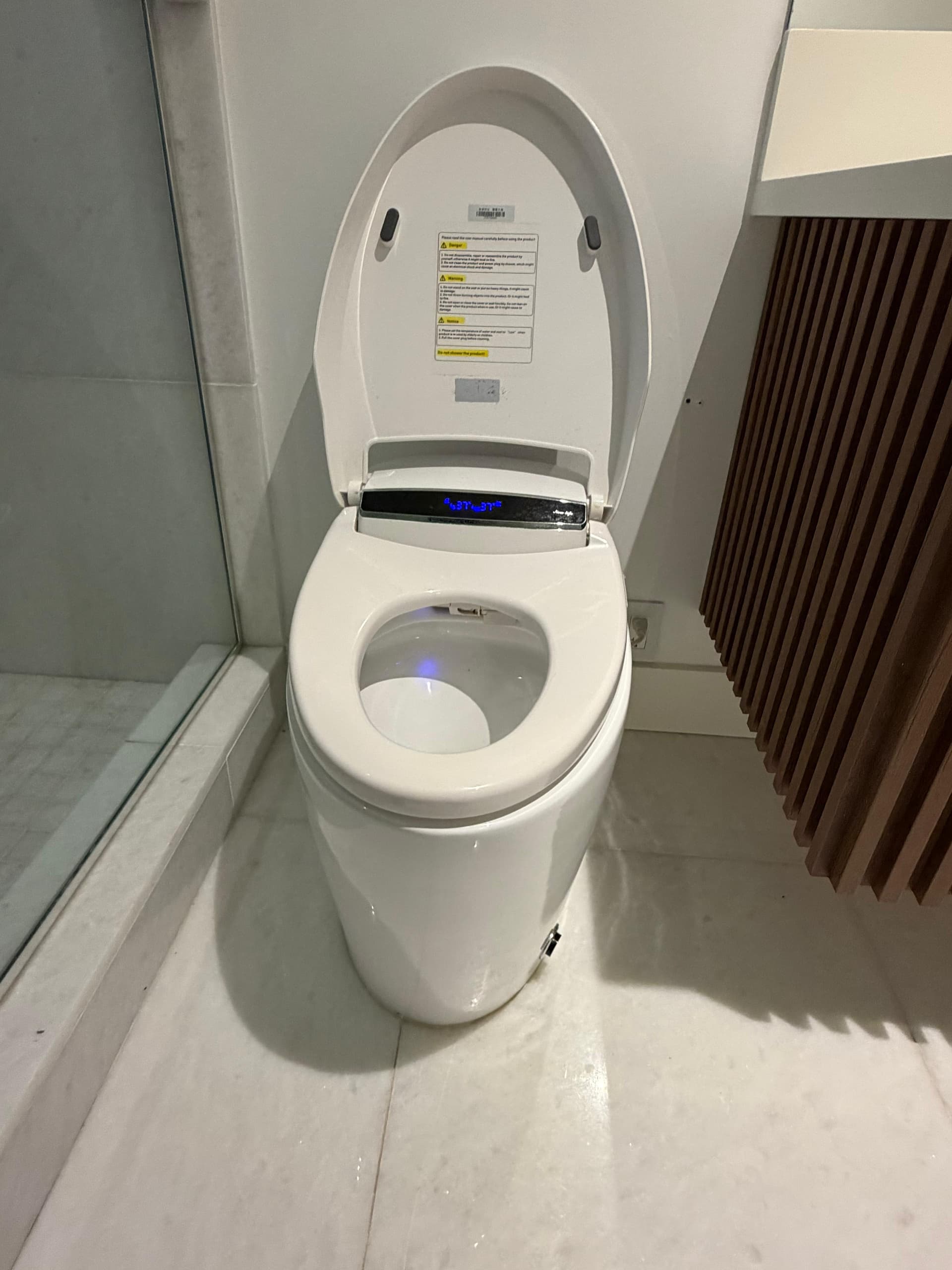 New Life Smart Toilet, modern one-piece tankless design with auto-opening lid, heated seat, bidet, and air drying