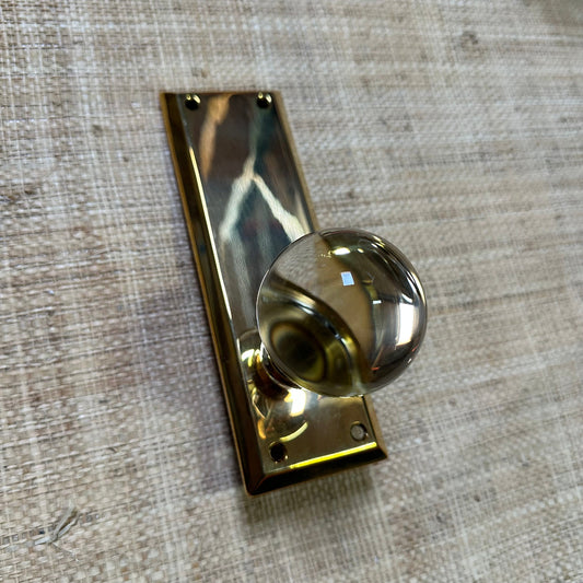 Gold door handle on a textured beige background